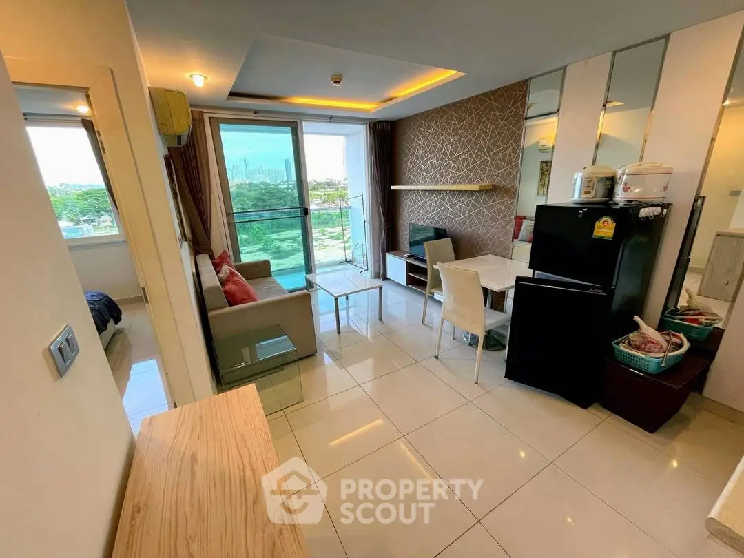 Modern living room with open layout, stylish decor, and city view balcony in urban apartment.