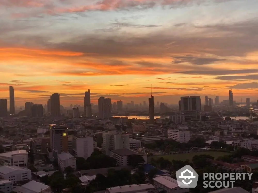 Stunning city skyline view at sunset with vibrant orange and pink hues.