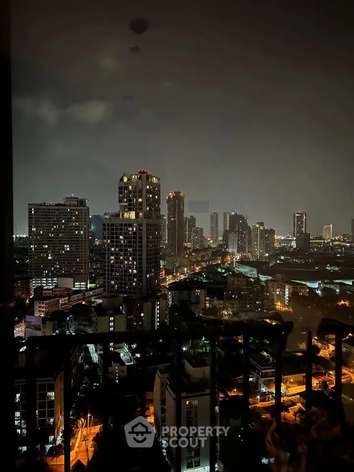 Stunning night cityscape view from a high-rise balcony, showcasing vibrant urban lights and skyline.