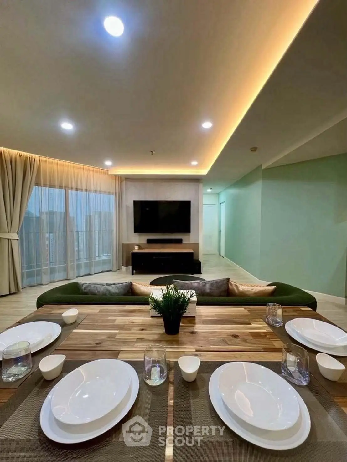 Spacious modern living room with elegant dining setup and ambient lighting