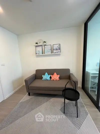 Modern living room with stylish decor and cozy sofa in a contemporary apartment.