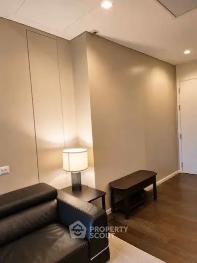 Modern living room with sleek leather sofa and ambient lighting