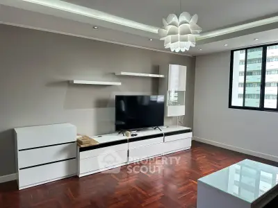 Spacious living room with modern furniture and hardwood floors in a bright apartment.