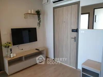 Modern living room with wall-mounted TV and stylish wooden door
