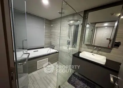 Luxurious modern bathroom with glass shower and sleek bathtub