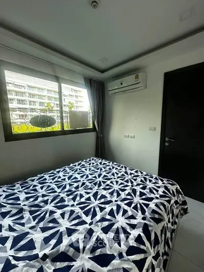 Cozy bedroom with modern decor and air conditioning, featuring a large window with a view.