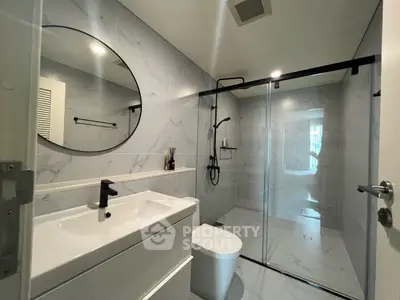 Modern bathroom with sleek fixtures and glass shower enclosure