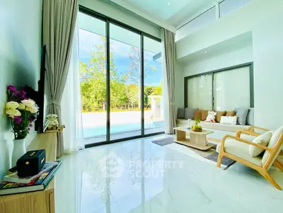 Spacious living room with pool view and modern decor