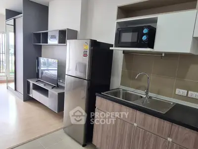 Modern open-plan kitchen with sleek appliances and stylish living area