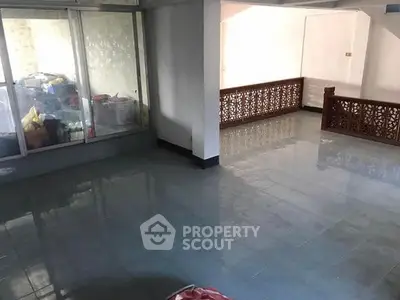 Spacious interior with tiled flooring and decorative railing, ideal for customization.