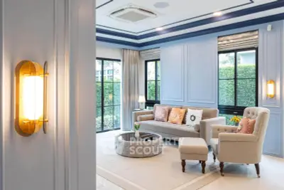 Luxurious living room with elegant decor and large windows overlooking greenery.