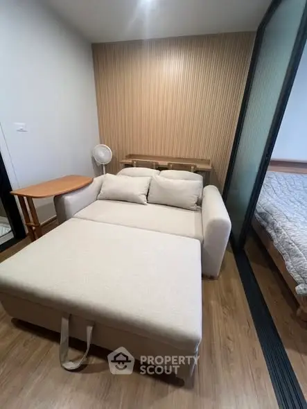 Cozy living room with modern sofa and wooden accents