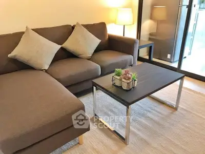 Cozy living room with modern sofa and stylish coffee table, perfect for relaxation.
