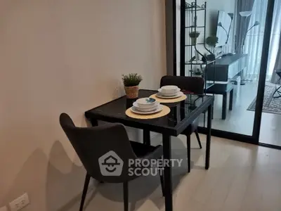 Modern dining area with elegant table setting and stylish decor in a contemporary apartment.