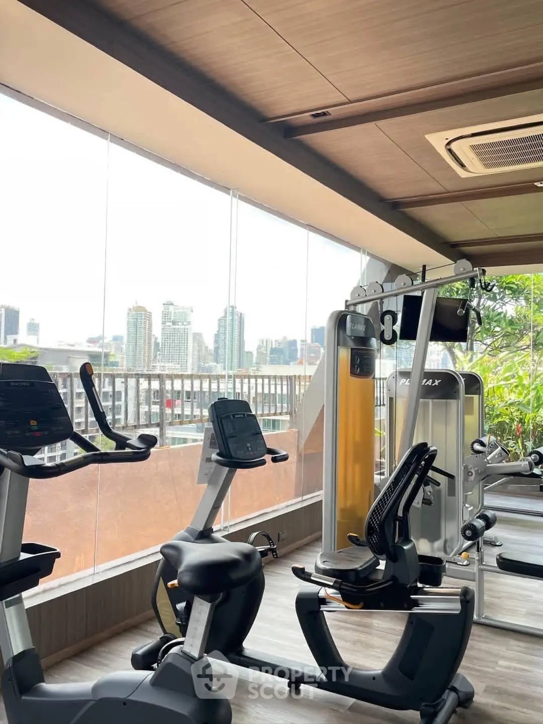 Modern gym with city view and state-of-the-art fitness equipment