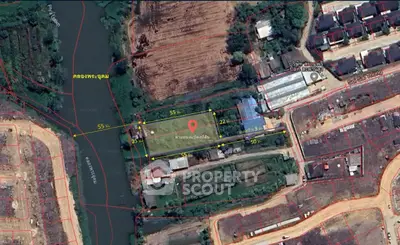 Aerial view of a property plot with surrounding landscape and river.