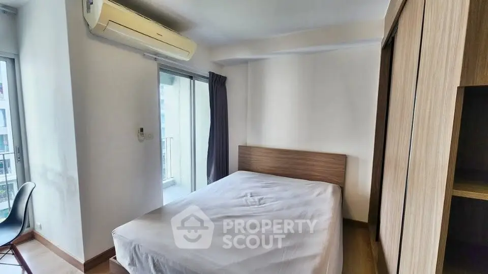 Cozy bedroom with balcony access in modern apartment