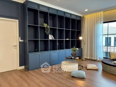 Elegant living room with built-in blue shelving and cozy seating area