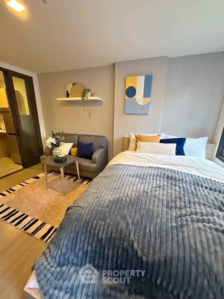 Cozy bedroom with modern decor and plush bedding in a stylish apartment.