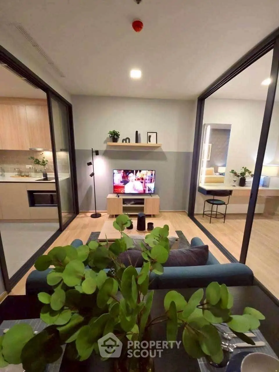 Modern open-plan living room with stylish decor and kitchen view