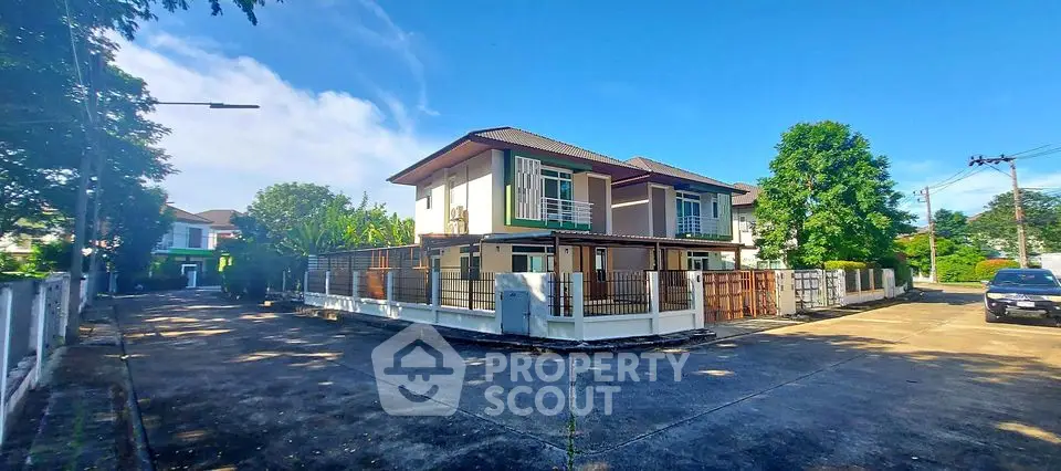 Charming suburban house with spacious driveway and lush greenery, perfect for family living.