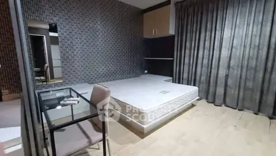 Modern bedroom with stylish wallpaper and minimalist furniture, featuring a comfortable bed and sleek glass desk.