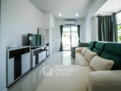 Spacious modern living room with large sofa and entertainment center