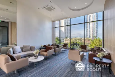 Expansive modern living area with floor-to-ceiling windows offering a panoramic city view, complemented by stylish furnishings.