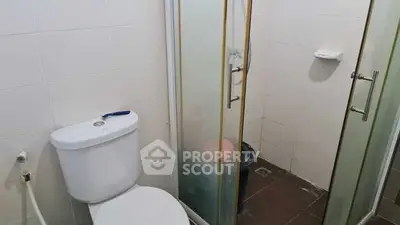 Compact bathroom with shower and toilet in modern apartment