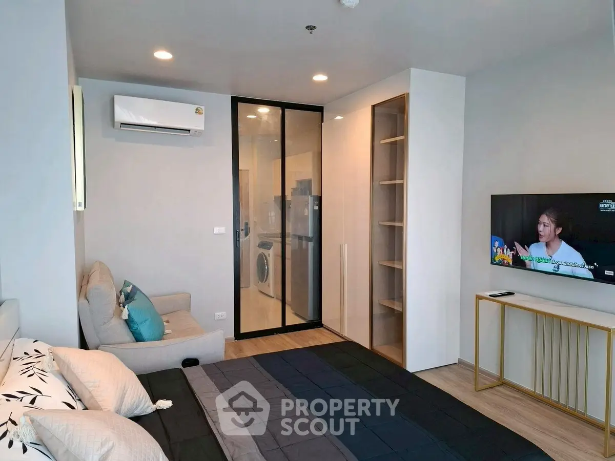 Modern bedroom with sleek design, featuring a glass partition and built-in storage, perfect for urban living.