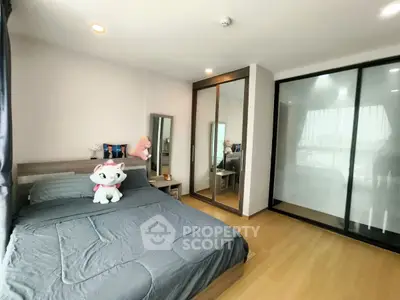 Modern bedroom with sleek design, featuring mirrored closet and plush bedding for ultimate comfort.