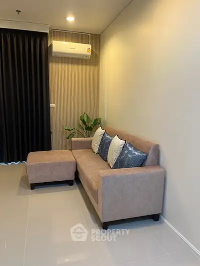 Modern living room with stylish sofa and air conditioning, perfect for cozy relaxation.