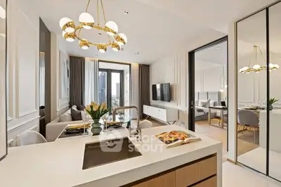 Luxurious open-plan kitchen and living area with elegant decor and modern lighting.