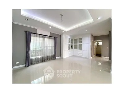 Spacious modern living room with elegant lighting and large windows