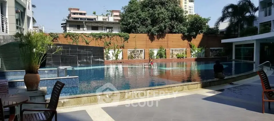 Luxurious residential pool area with modern design and lush greenery