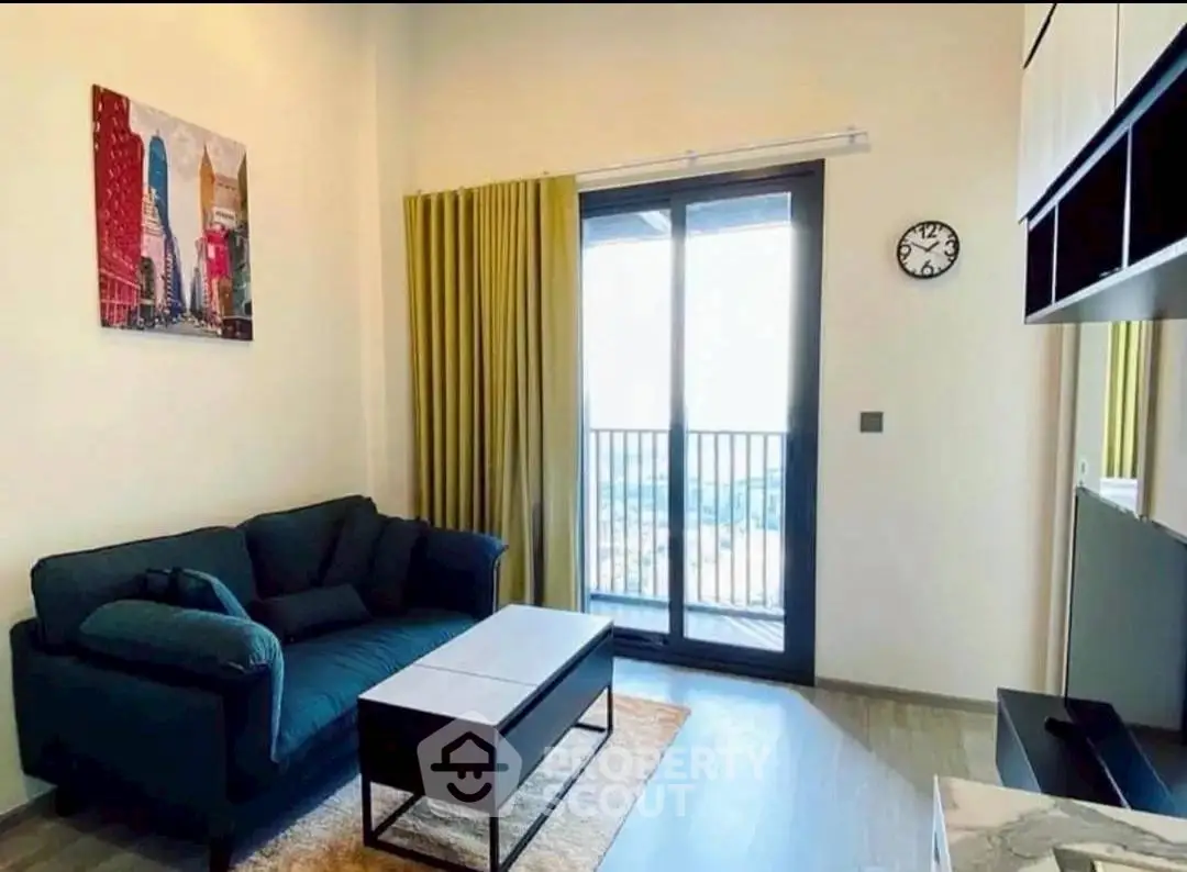 Modern living room with balcony view, stylish decor, and cozy seating area.