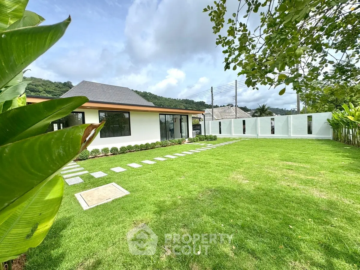 Modern single-story home with lush green lawn and scenic surroundings, perfect for tranquil living.
