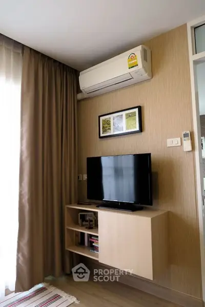 Modern living room with wall-mounted TV and air conditioning unit