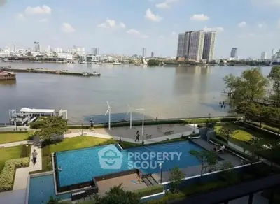 Stunning riverside view with pool and cityscape, perfect for luxury living.