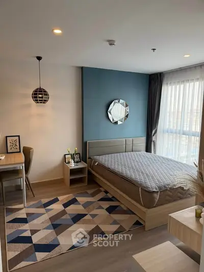 Modern bedroom with stylish decor and natural light in a contemporary apartment.