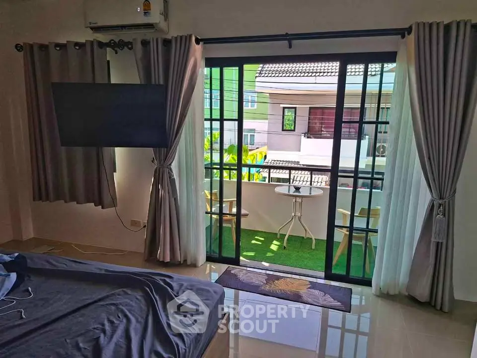 Spacious bedroom with balcony access and modern decor