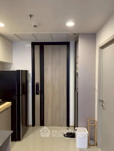 Modern apartment entrance with sleek kitchen and stylish decor
