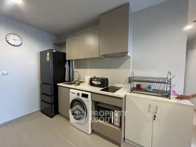 Modern kitchen with sleek appliances and compact design