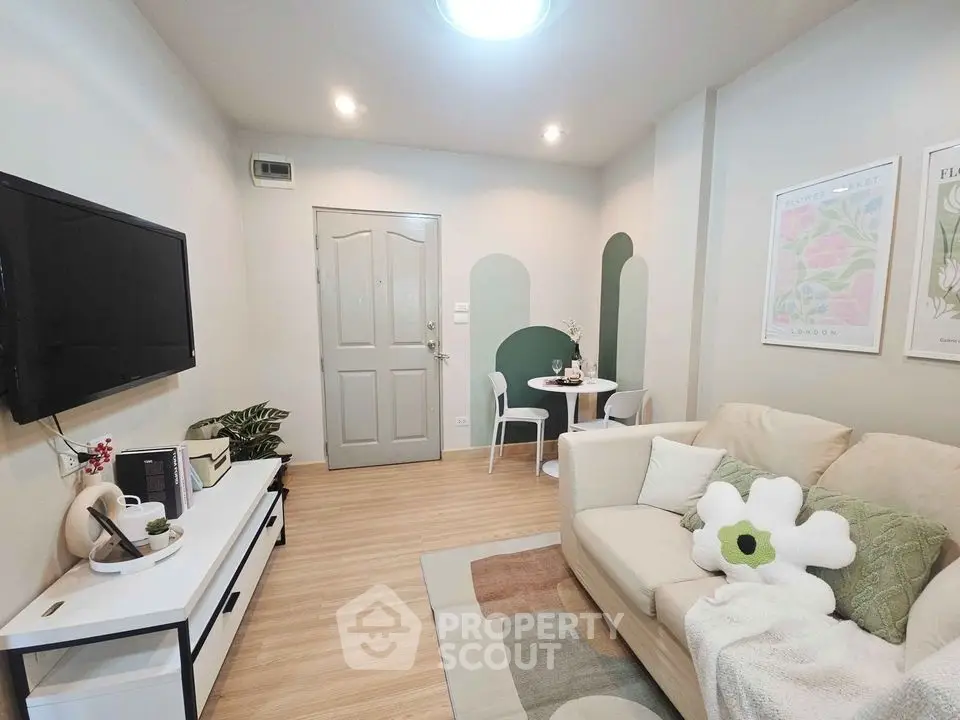 Charming living room with modern decor, cozy seating, and stylish wall art in a bright apartment.