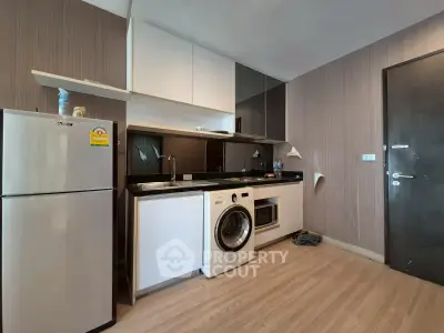 Modern kitchen with washing machine and sleek cabinetry