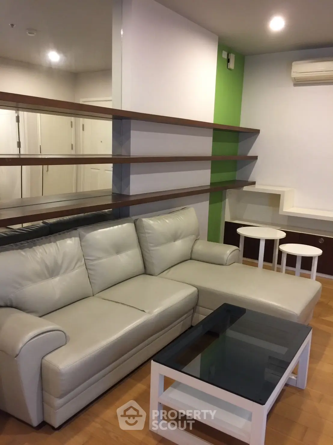 Modern living room with sleek leather sofa and stylish shelving