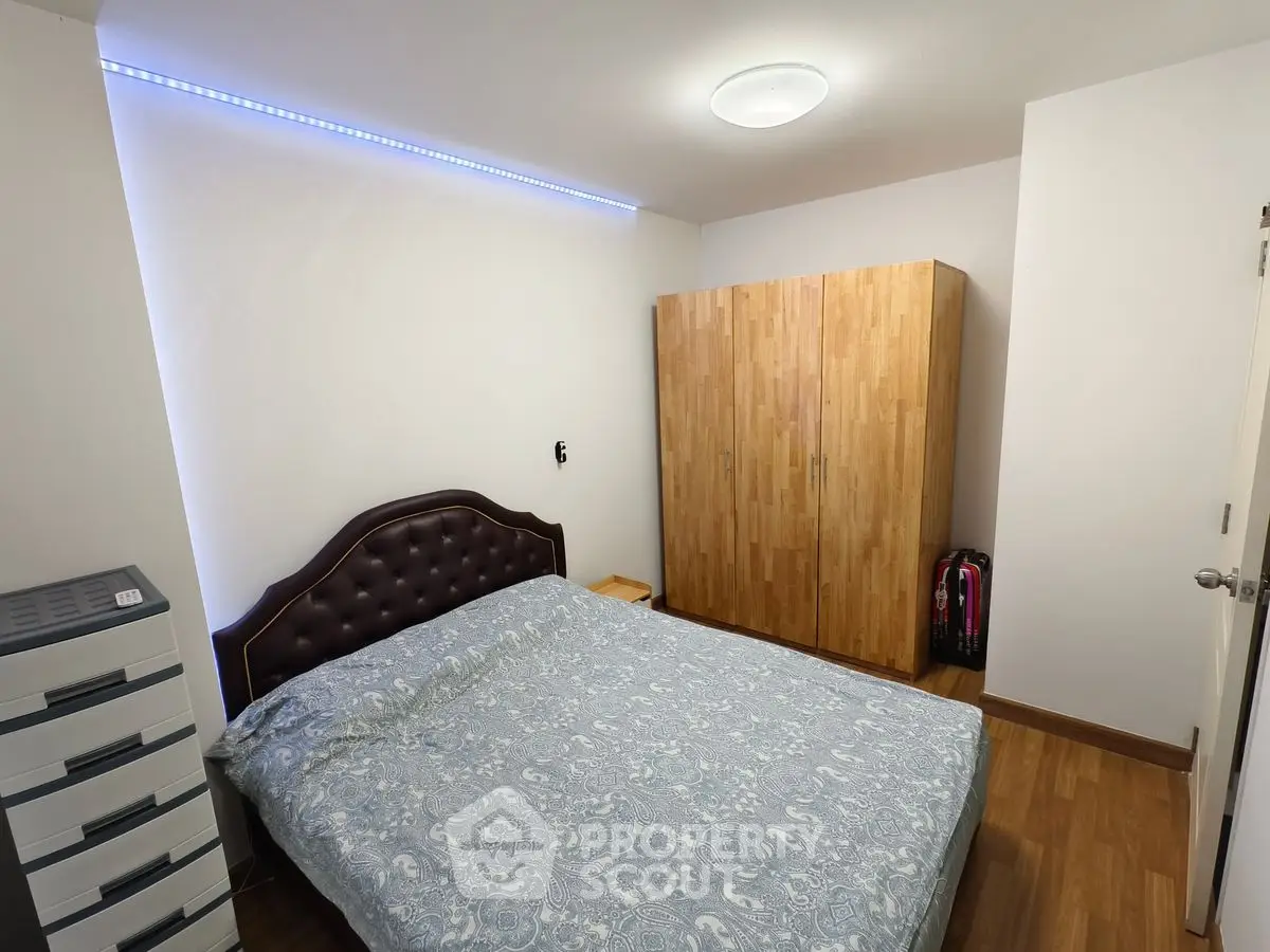 Cozy bedroom with wooden wardrobe and modern lighting
