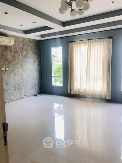 Spacious living room with modern design and large windows for natural light.