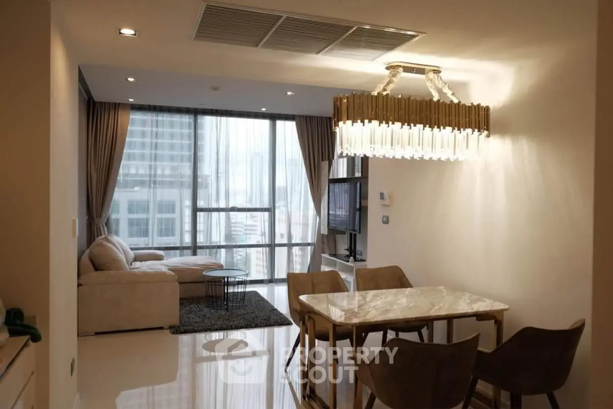 Luxurious modern living room with elegant chandelier and city view