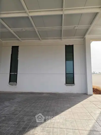 Modern building entrance with tiled flooring and sleek windows